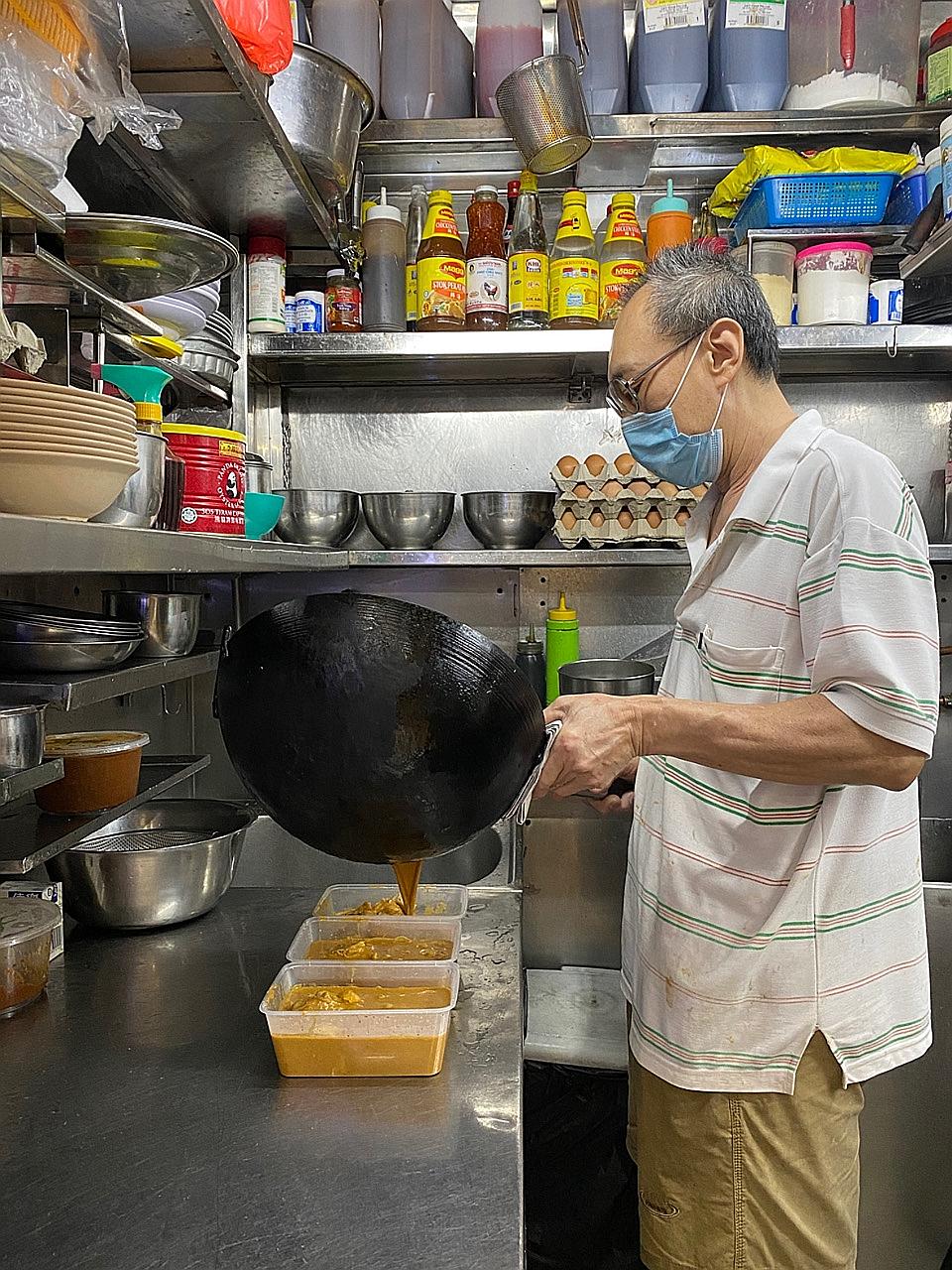 Mr Yeo See Hock, who runs Meng Kee Seafood stall at Pasir Panjang Food Centre, ladling out dishes for delivery orders. Mr Yeo said that because he has to keep prices low, the profit margins are also low. He could not afford the 30 per cent commission