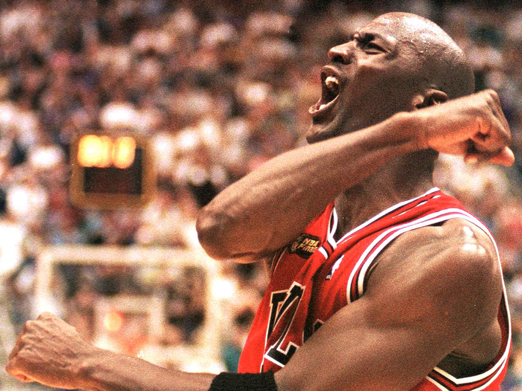 Michael Jordan of the Chicago Bulls celebrating after winning Game Six of the 1998 NBA Finals against the Jazz at the Delta Centre in Utah. He sank the winning jumper to give the Bulls a 87-86 victory and their sixth NBA title.