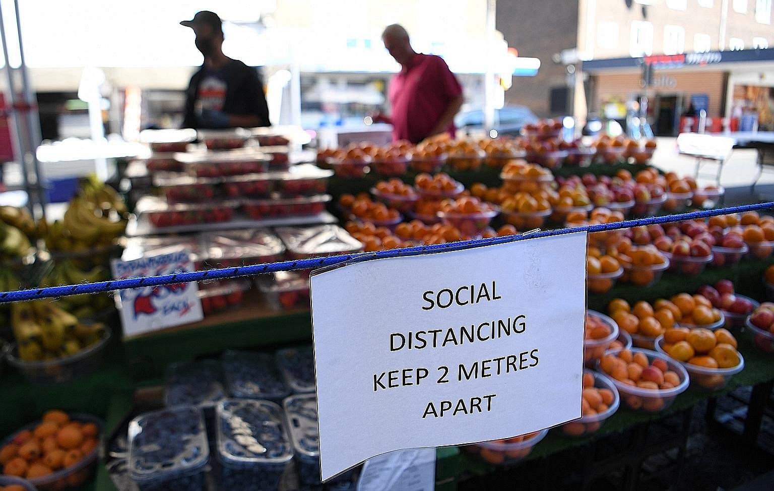 A social distancing notice at an open-air market in London as England eased its rules over public gatherings and other activities. PHOTOS: EPA-EFE Shooting of a film resumed in the Montmartre district of Paris yesterday as France lifted many of its l