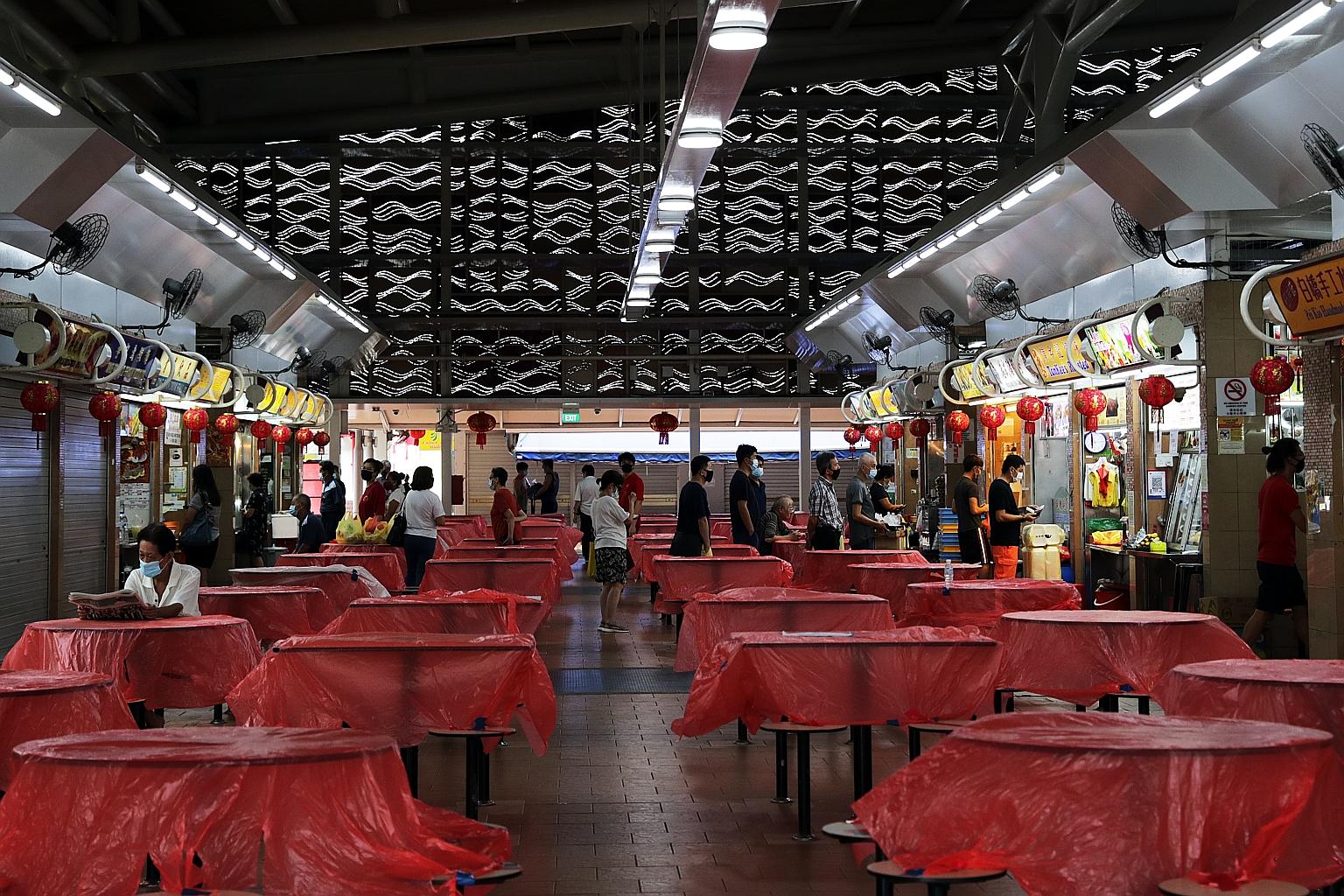 People buying food at the Pek Kio Market and Food Centre yesterday, on the last day of the circuit breaker period. There were no new community Covid-19 cases announced yesterday. This is the first time since Feb 23 that there were no new community ca