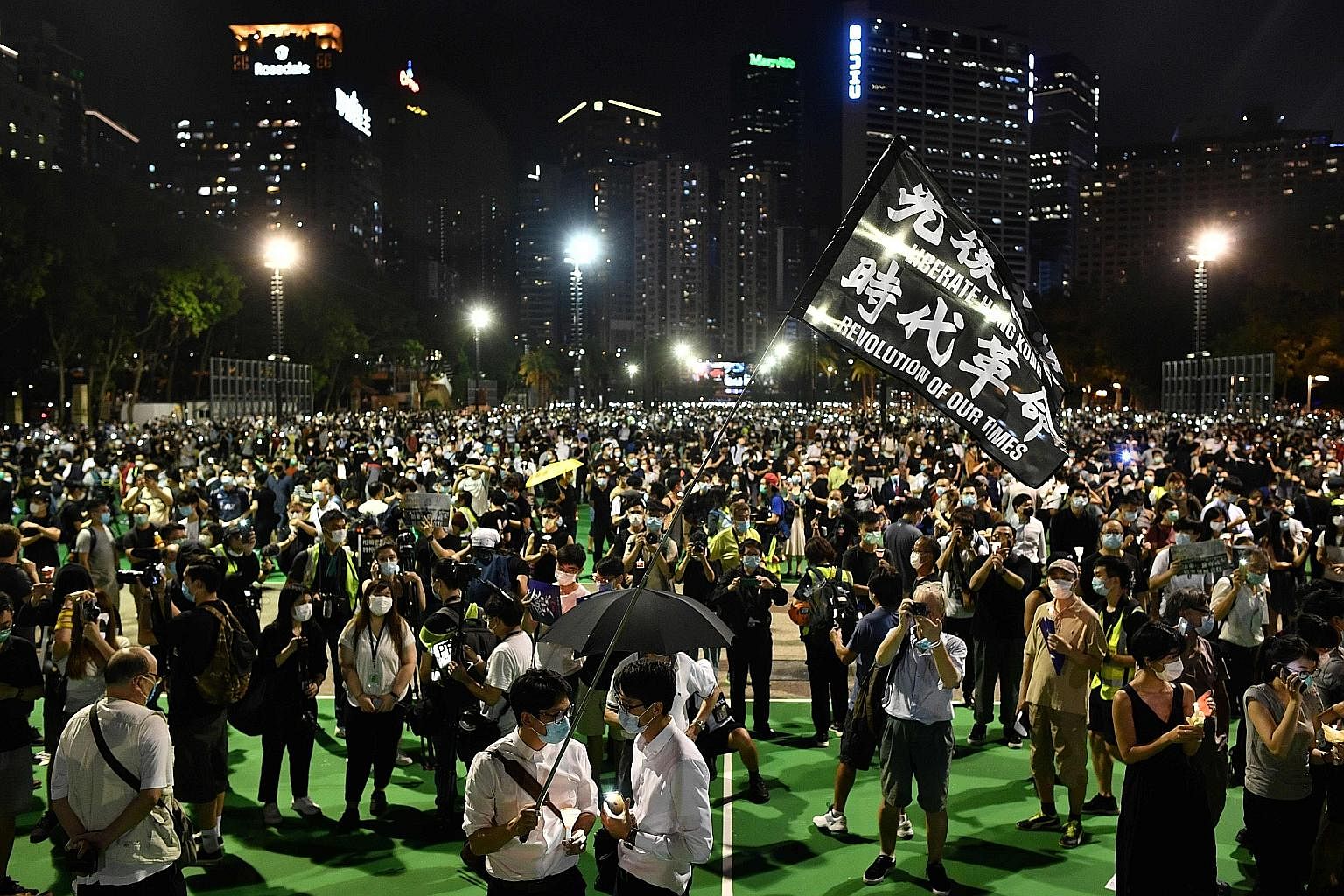 Activists at a candlelit vigil in Victoria Park in Hong Kong yesterday evening to commemorate the Tiananmen crackdown. The event had been banned due to coronavirus concerns.