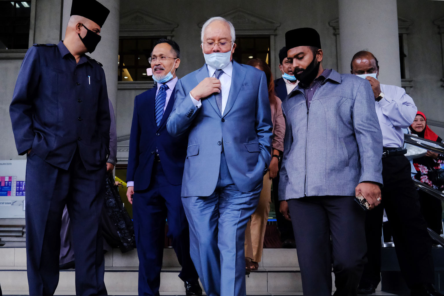 Najib Razak, Malaysia's former prime minister, leaving the Kuala Lumpur Courts Complex on Thursday. In all, he faces a total of 42 counts of corruption, money-laundering and abuse of power spanning five different cases tied to 1MDB. PHOTO: BLOOMBERG