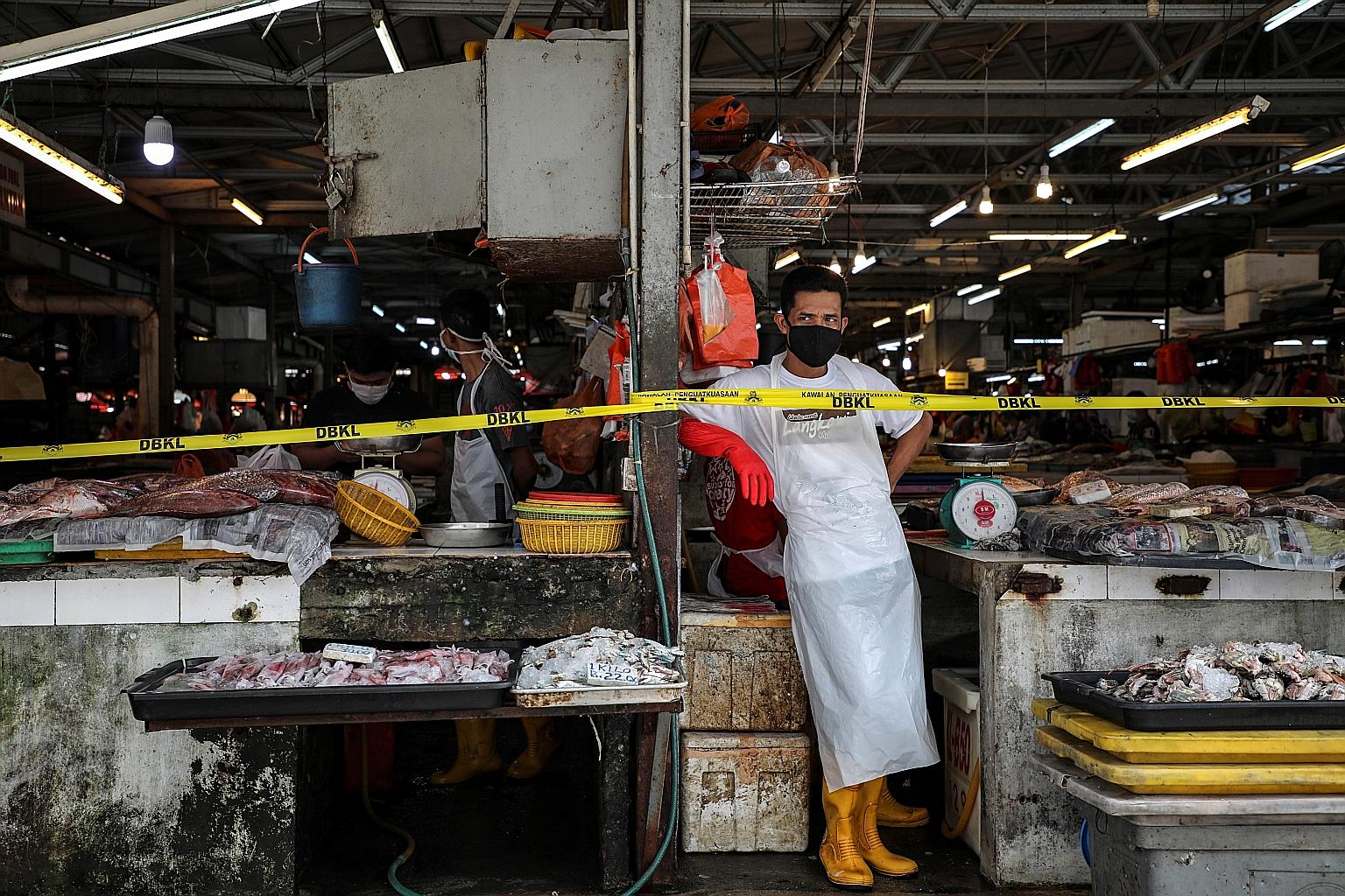 A vendor waiting for customers at a market, amid the movement control order due to the Covid-19 outbreak, in Kuala Lumpur in March. Senior Minister Ismail Sabri Yaakob said open markets, morning markets, night markets and bazaars can resume operation