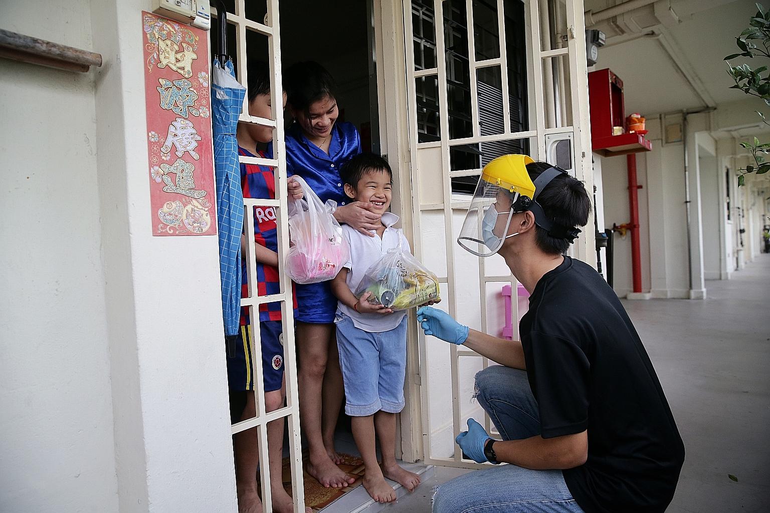 Beneficiaries of The Straits Times School Pocket Money Fund receiving packs of soya products from Mr Bean last month. Prime Minister Lee Hsien Loong pointed to the unity and resilience of Singaporeans as a key ingredient that will help Singapore weat