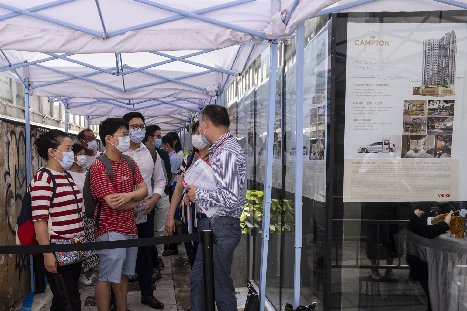 Prospective buyers waiting outside the sales office of The Campton residential project in Hong Kong last Tuesday. Despite the city's contracting economy, existing home prices have risen by 1.2 per cent this year.