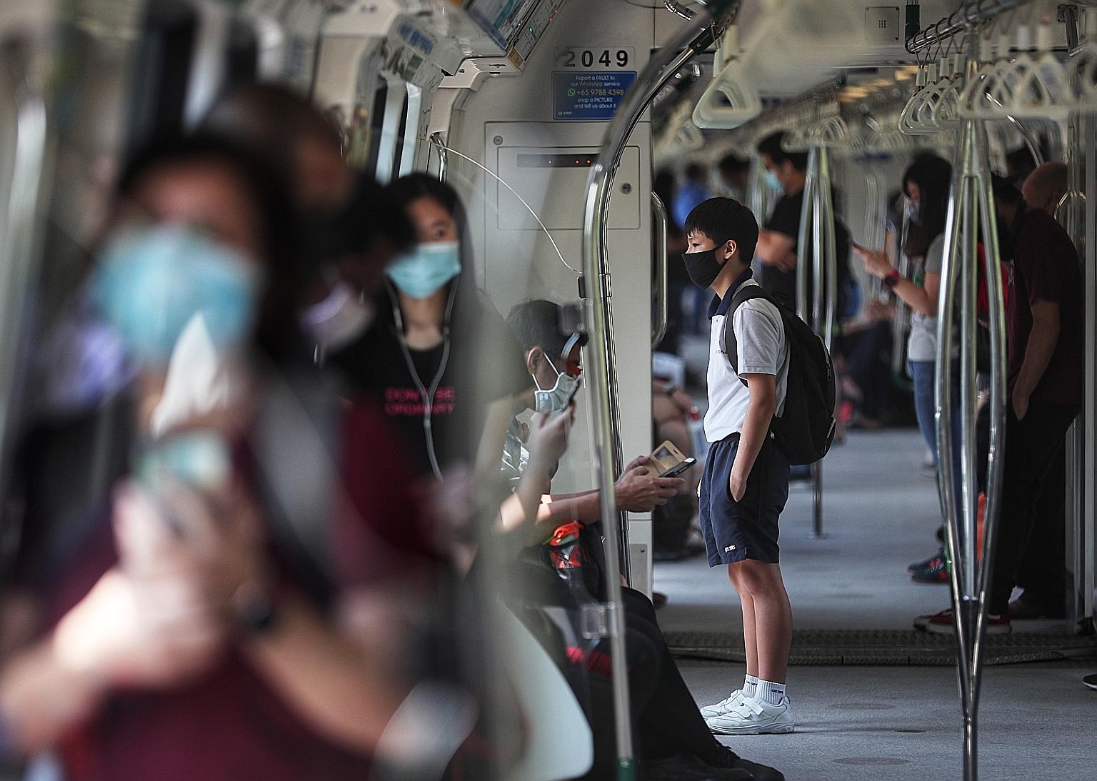 Commuters on an MRT train yesterday. As new evidence emerged, the authorities here changed their advice on the wearing of masks, and people's willingness to adapt has been invaluable in the fight against Covid-19, said Deputy Prime Minister Heng Swee