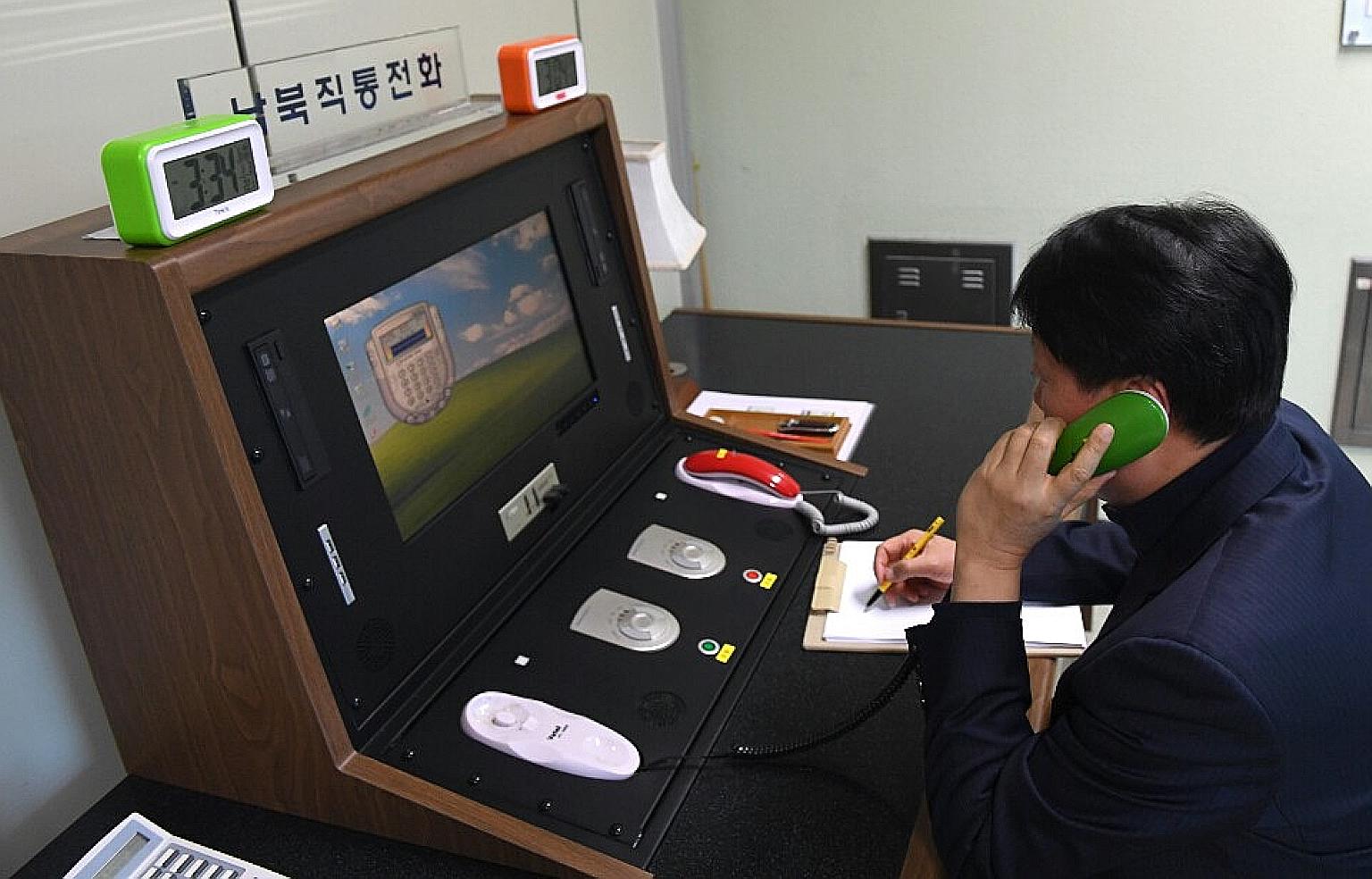 A South Korean official making a test call to North Korea via a hotline at an inter-Korean liaison office in Panmunjom. Pyongyang said it plans to shut down all contact with Seoul.