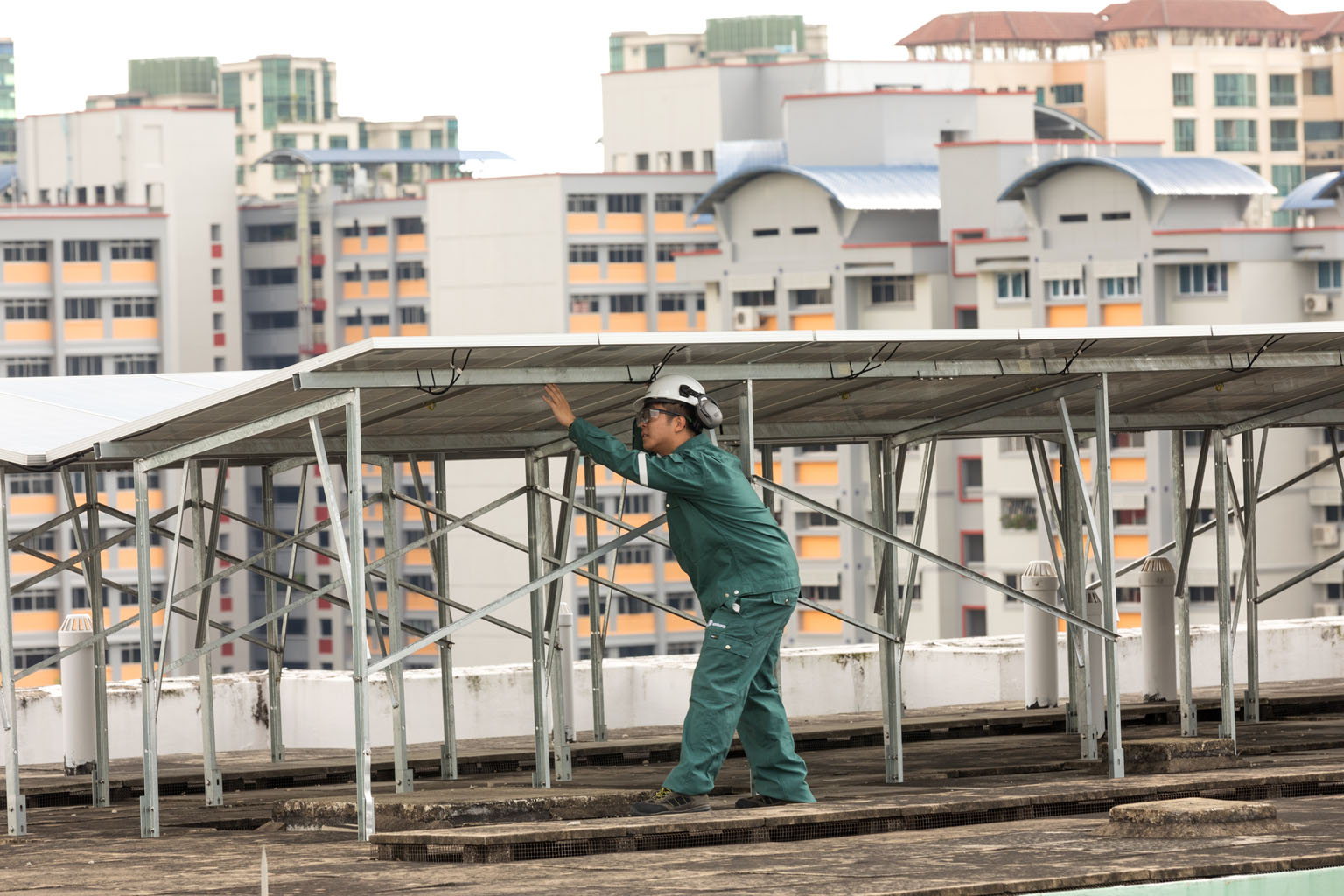 A worker inspecting solar panels at a Sembcorp HDB rooftop project site in Choa Chu Kang. An analyst says the demerger will allow Sembcorp Industries to focus on its energy and urban solutions businesses. PHOTO: SEMBCORP INDUSTRIES