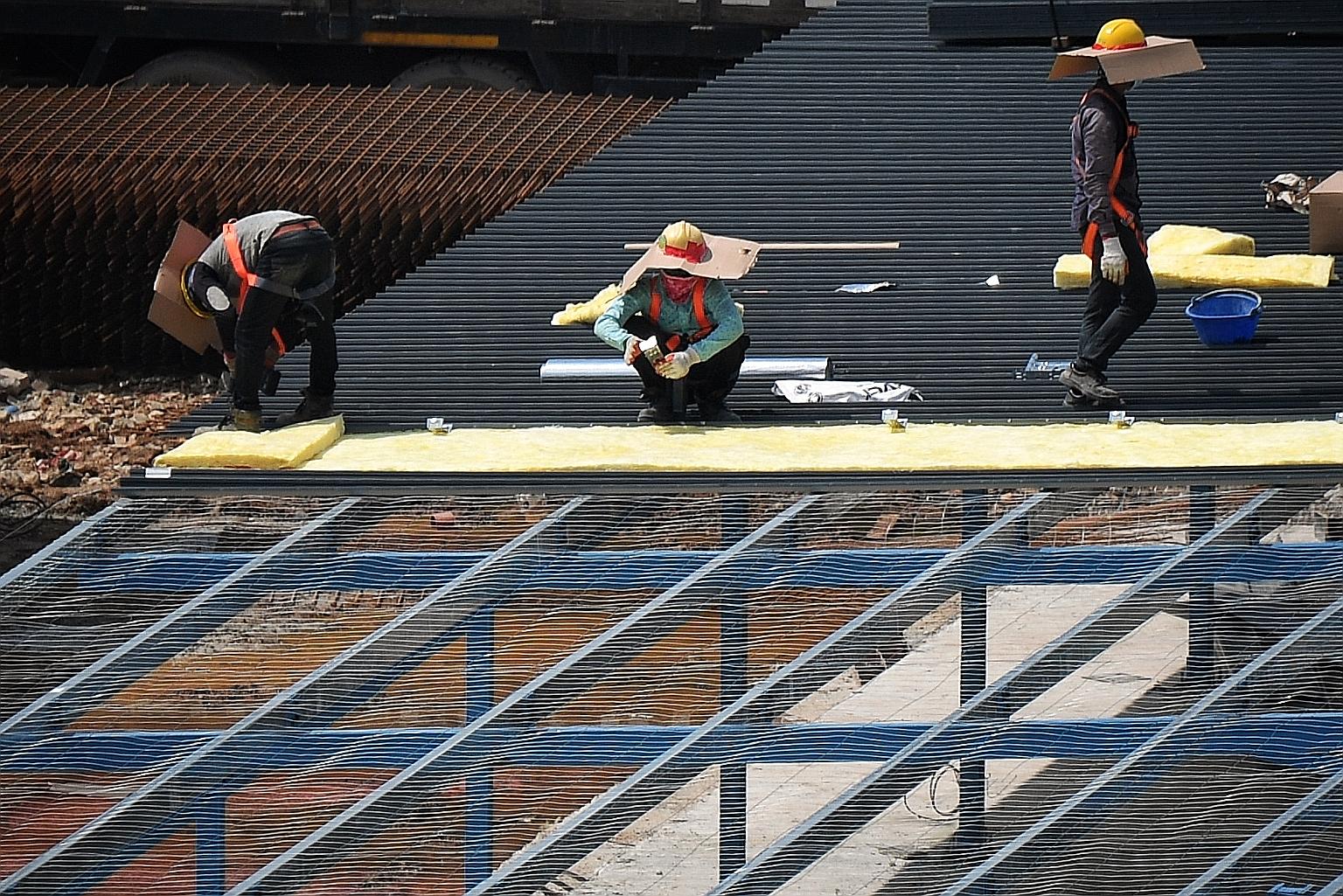 Work on a new Quick Build Dormitory (QBD) was in full swing at an empty plot of land next to Choa Chu Kang Avenue 7 yesterday. Eight such dormitories - temporary structures that can last two to three years - will be ready by the end of the year to ho