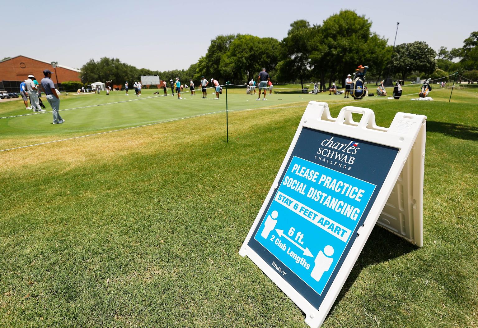 A sign at the Colonial Country Club reminding people to maintain social distancing during a practice round before the Charles Schwab Challenge, which tees off today after the PGA Tour's Covid-19 break.