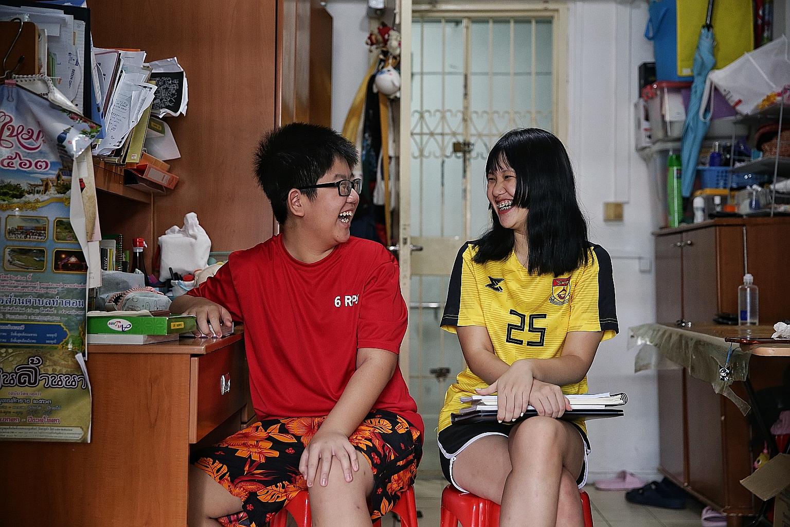 Student Loh Miao Xin with her younger brother Khim San. Their single mother lost her job at a hawker stall during the circuit breaker period. ST FILE PHOTO