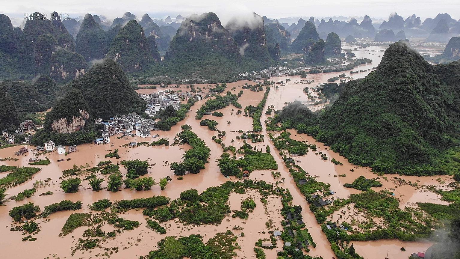 A flooded village in Yangshuo county in Guangxi Zhuang Autonomous Region, where six people were reported dead and one missing, on Sunday. People in Yangshuo, a popular tourist destination, had to evacuate on bamboo rafts.