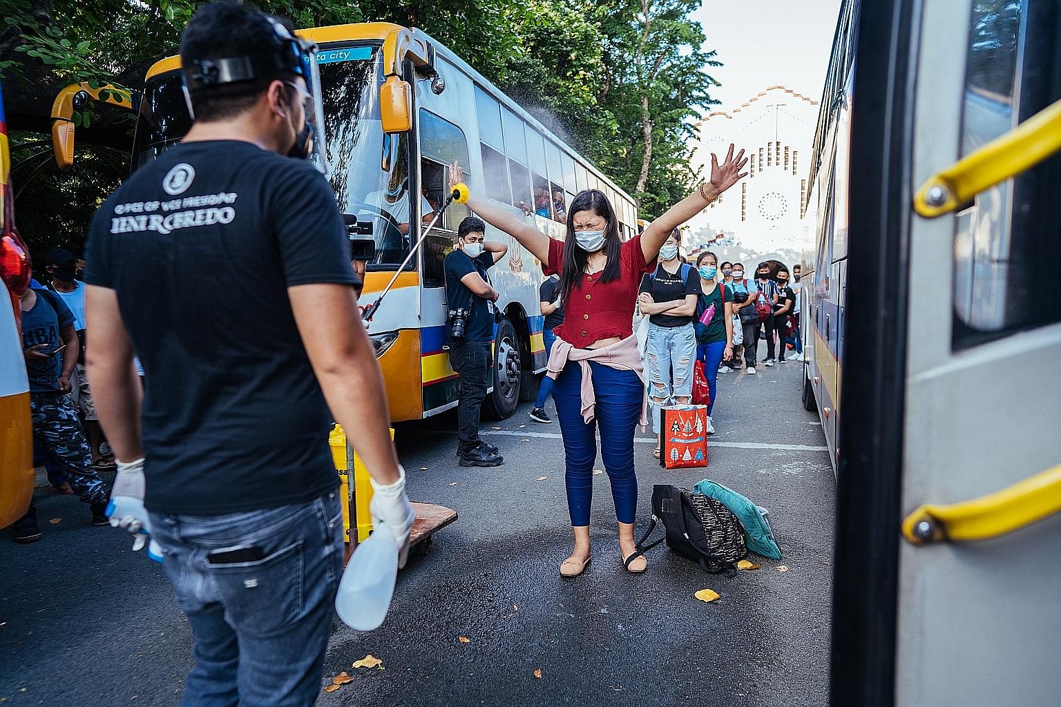 People desperate for a ride out of Metro Manila queueing up to be disinfected before boarding buses that would take them to their home towns. About one million people in the Philippine capital lost their jobs after an abrupt lockdown to contain the c