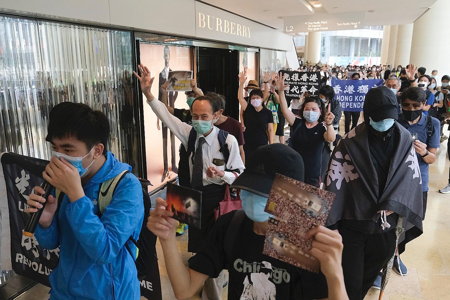 Demonstrators marching inside Pacific Place mall in the Admiralty district of Hong Kong during a pro-democracy protest yesterday. PHOTO: BLOOMBERG