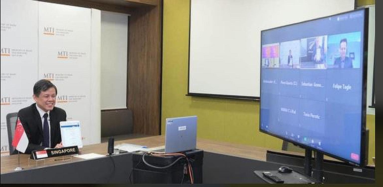 Trade and Industry Minister Chan Chun Sing in a video call with his New Zealand and Chilean counterparts yesterday, during which they signed the Digital Economy Partnership Agreement electronically.