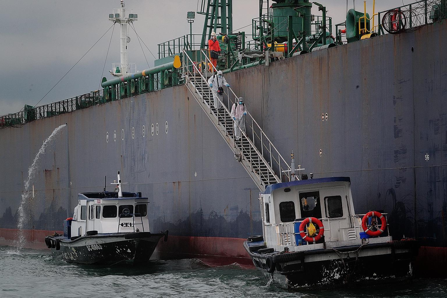 Seafarers disembarking from the STI Carnaby vessel off Marina South Pier yesterday as part of a crew change in Singapore via chartered flights. The Maritime and Port Authority of Singapore has seen a sharp increase in daily crew change applications s