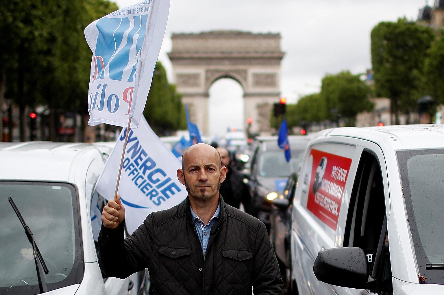 A police officer at a protest yesterday in Paris against the government's reforms, including a ban on the controversial chokehold method of arrest. The French police say they are being unfairly treated to calm the public. PHOTO: REUTERS