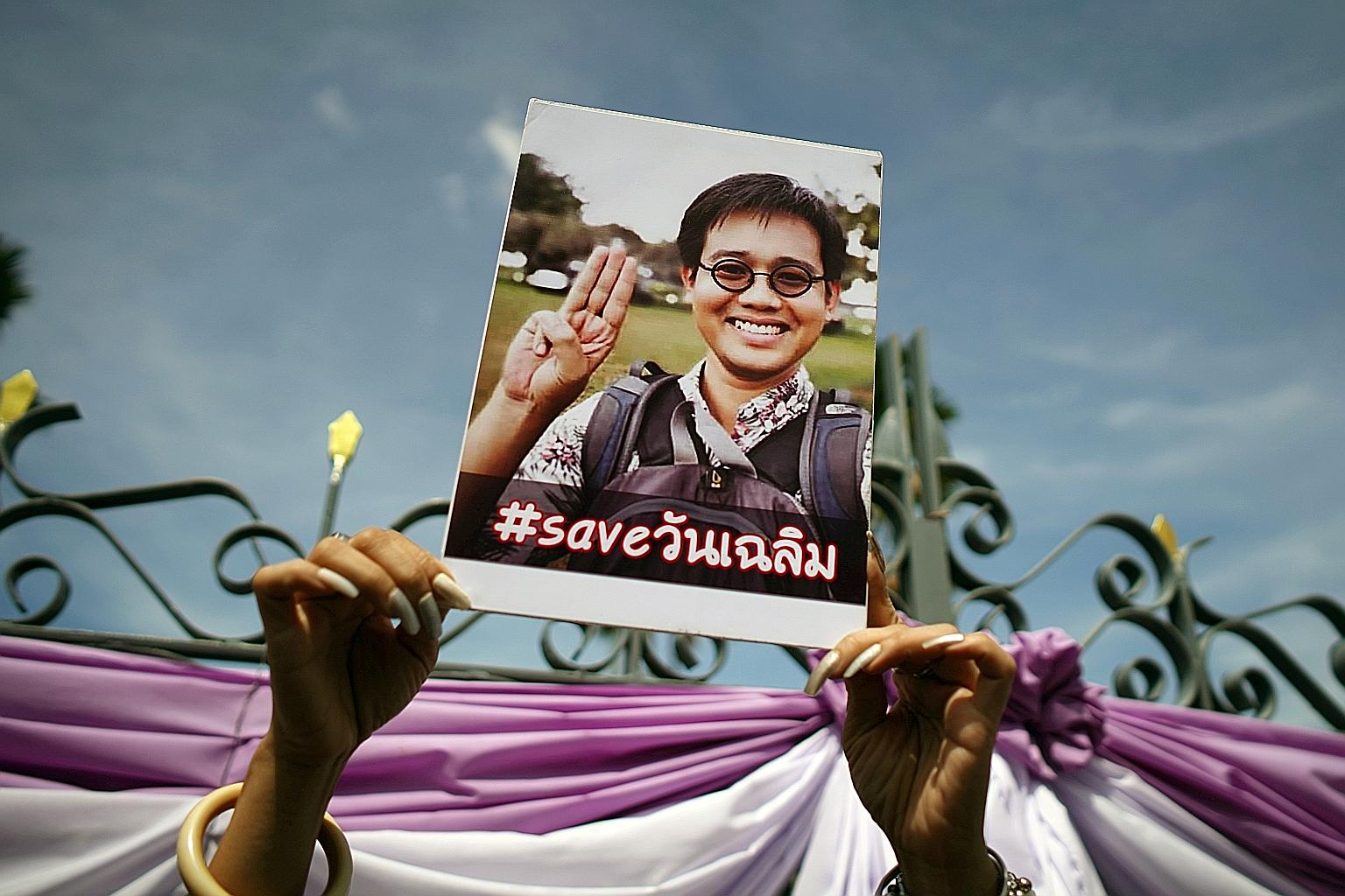 A poster of missing Thai activist Wanchalearm Satsaksit being held up during a protest outside Prime Minister Prayut Chan-o-cha's offices in Bangkok yesterday. Wanchalearm fled from Thailand following a 2014 military coup and is suspected to have bee
