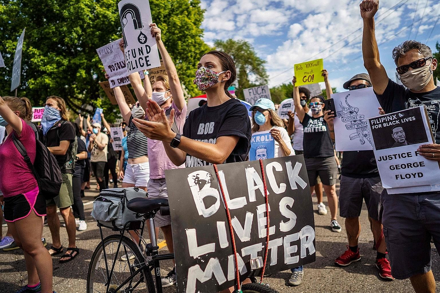 Protesters outside the Minneapolis Police and Fire Union offices on Friday. As "Black Lives Matter" graffiti and banners appear around the world, and monuments glorifying colonial and Confederate figures are destroyed, institutions in Britain and Ame
