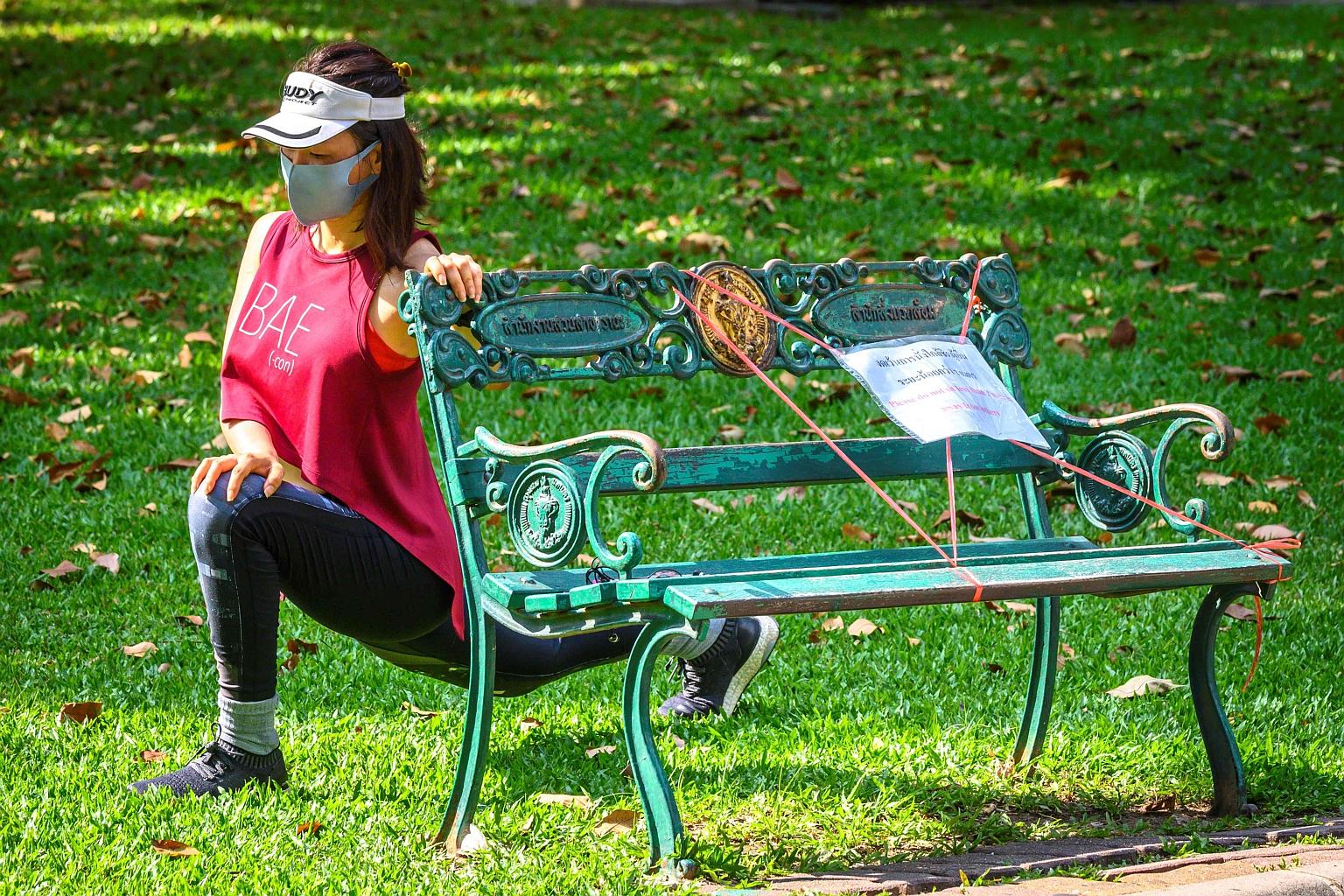 A woman doing stretching exercises with the aid of a bench. PHOTO: AGENCE FRANCE-PRESSE