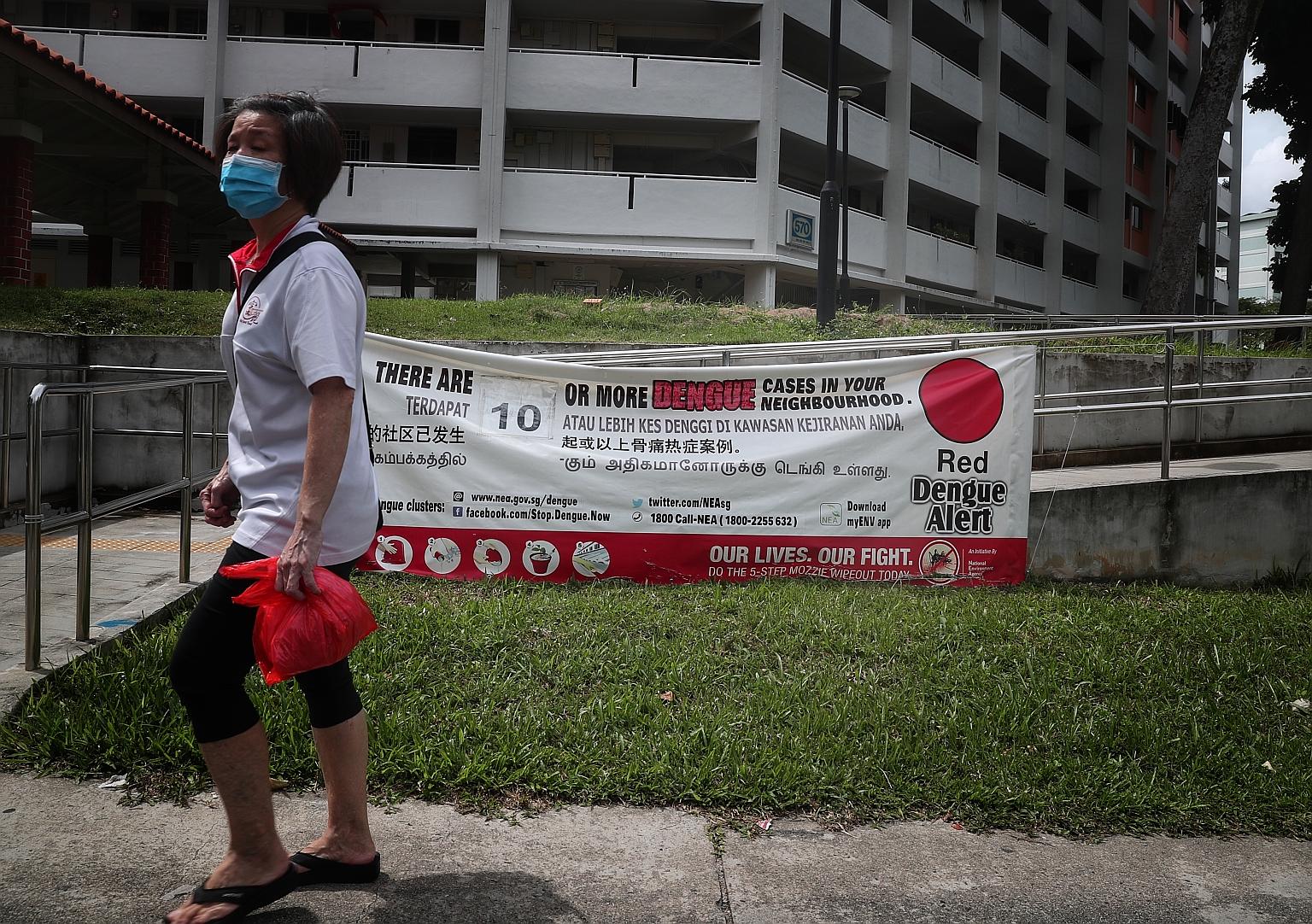 A dengue alert banner in Ang Mo Kio earlier this month. Over 10,700 people have been infected with dengue this year, and at least 12 have died. ST PHOTO: KELVIN CHNG