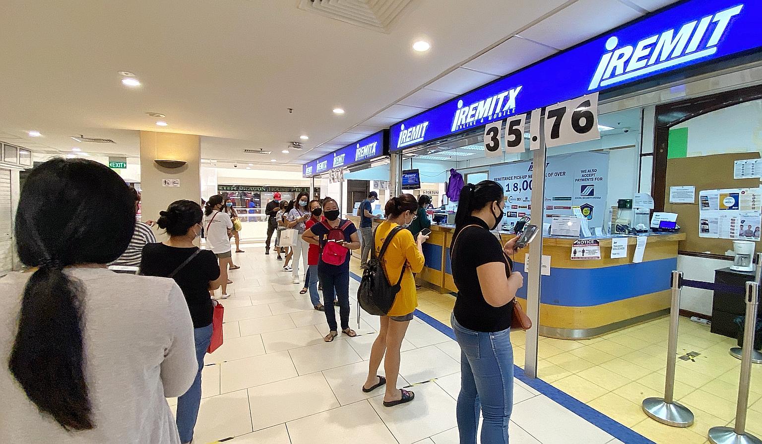The queue outside a remittance service at Lucky Plaza on June 4, days after the circuit breaker ended. The Monetary Authority of Singapore said yesterday it has worked with all licensed remittance agents at City Plaza, Lucky Plaza and Peninsula Plaza