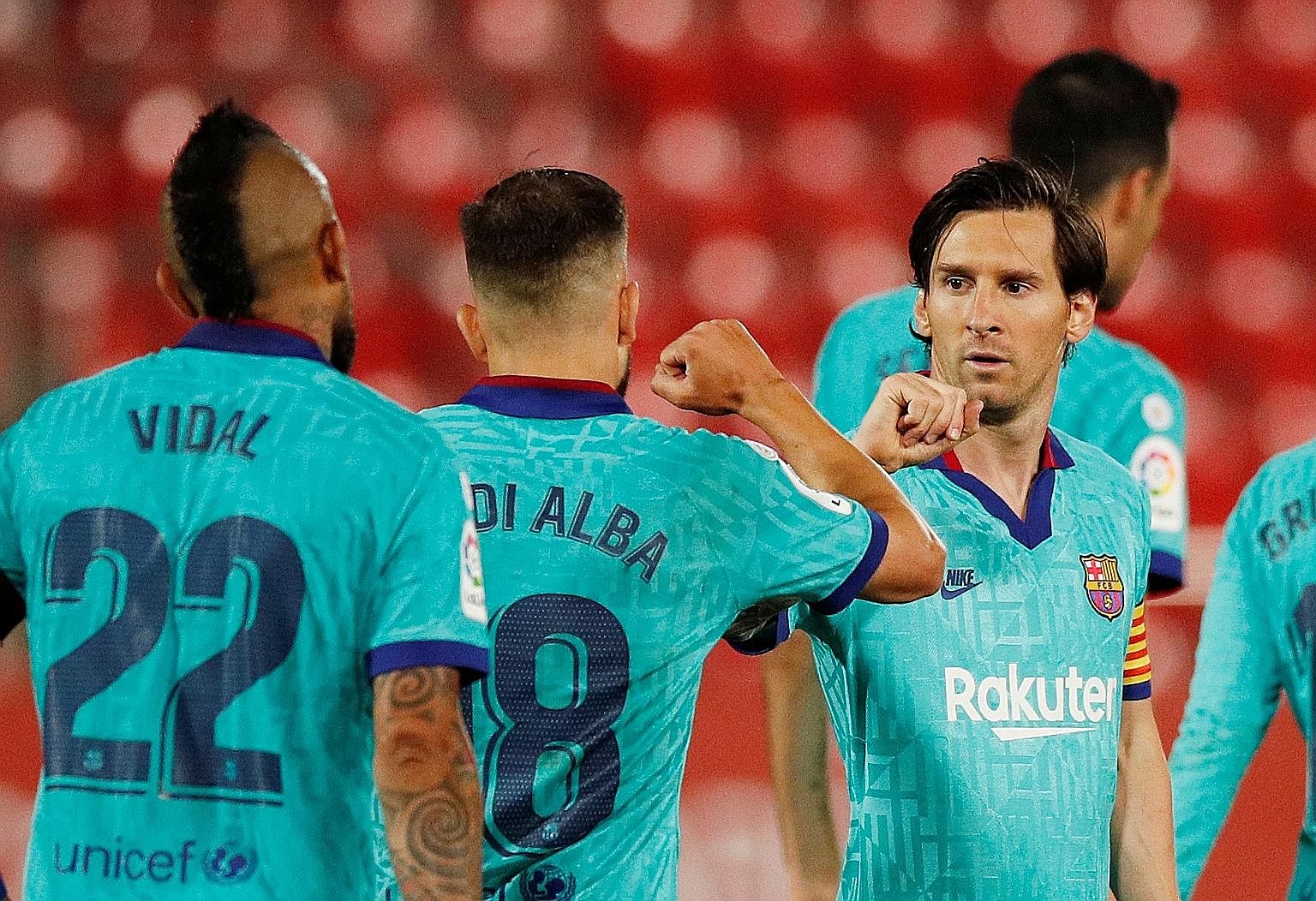 Barcelona's Lionel Messi celebrating their second goal - scored by Martin Braithwaite (not pictured) - with Jordi Alba.