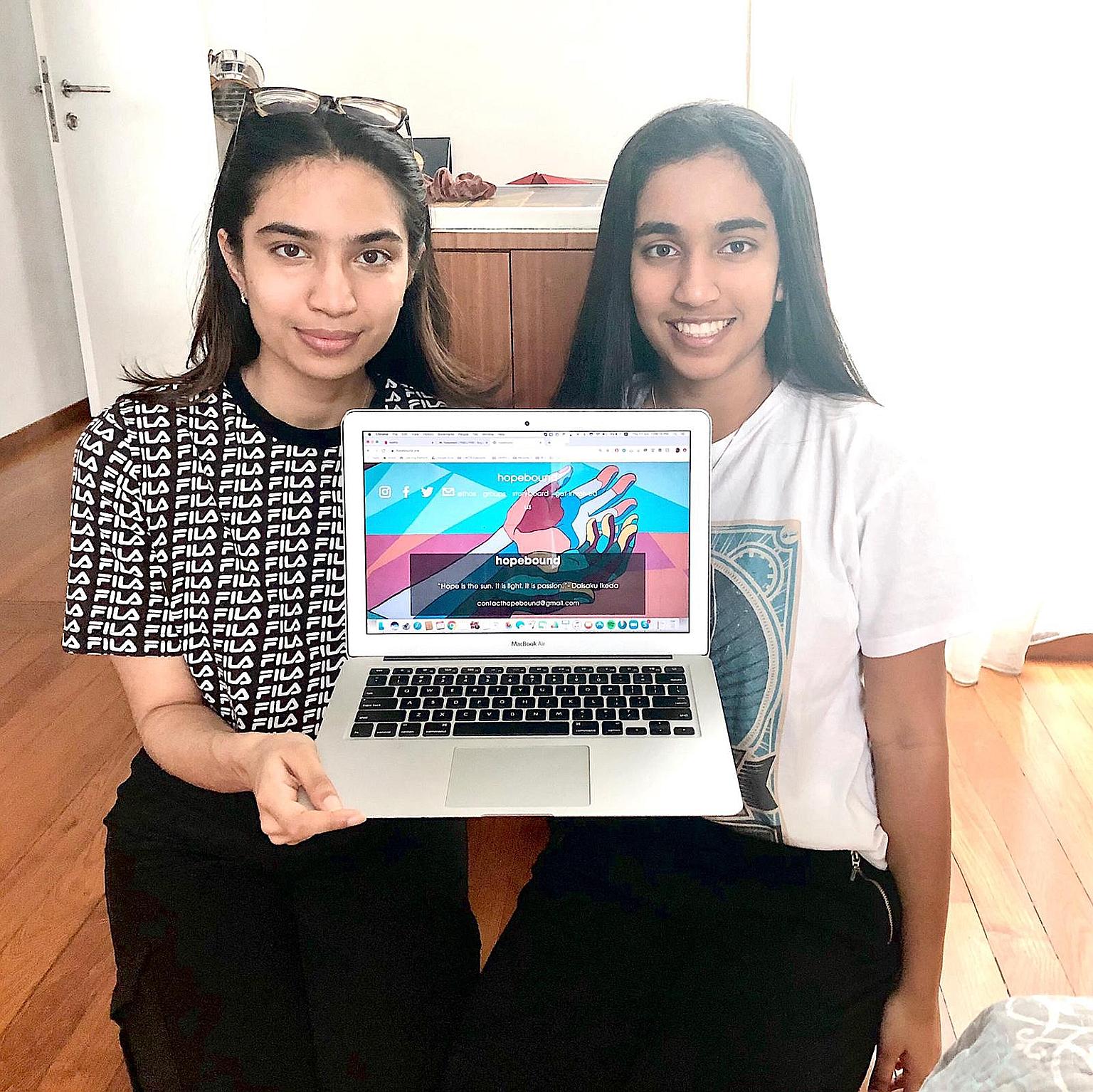 Ms Nishka Menon (left), 21, and her sister Ayesha, 17, showing their website hopebound, which collates resources for people affected by the coronavirus pandemic.