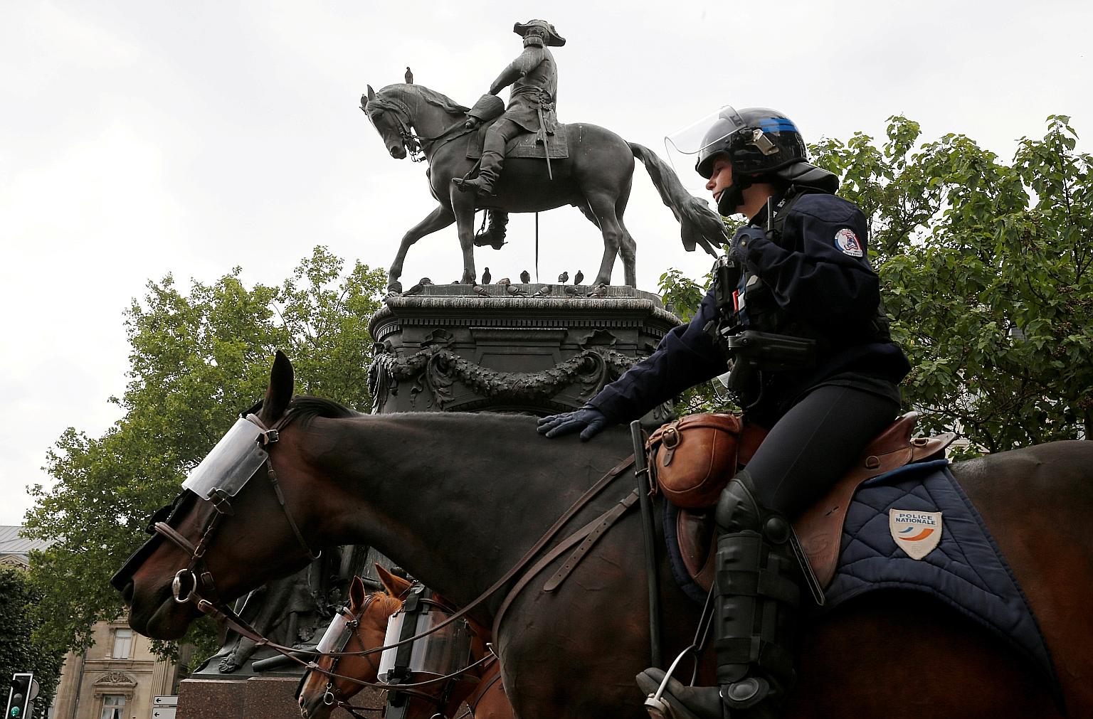 A French police officer guarding a statue of Louis Faidherbe, a French general and colonial administrator in the 19th century, in Lille before a protest against alleged police brutality last week. PHOTO: REUTERS
