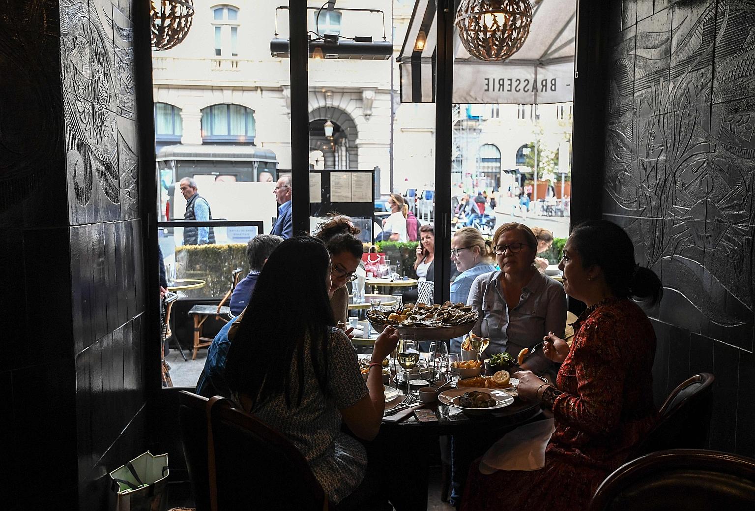 Customers at a restaurant in Paris yesterday. Before the sooner-than-expected reopening announced on Sunday, eateries in and around the French capital could only serve clients on outdoor terraces.