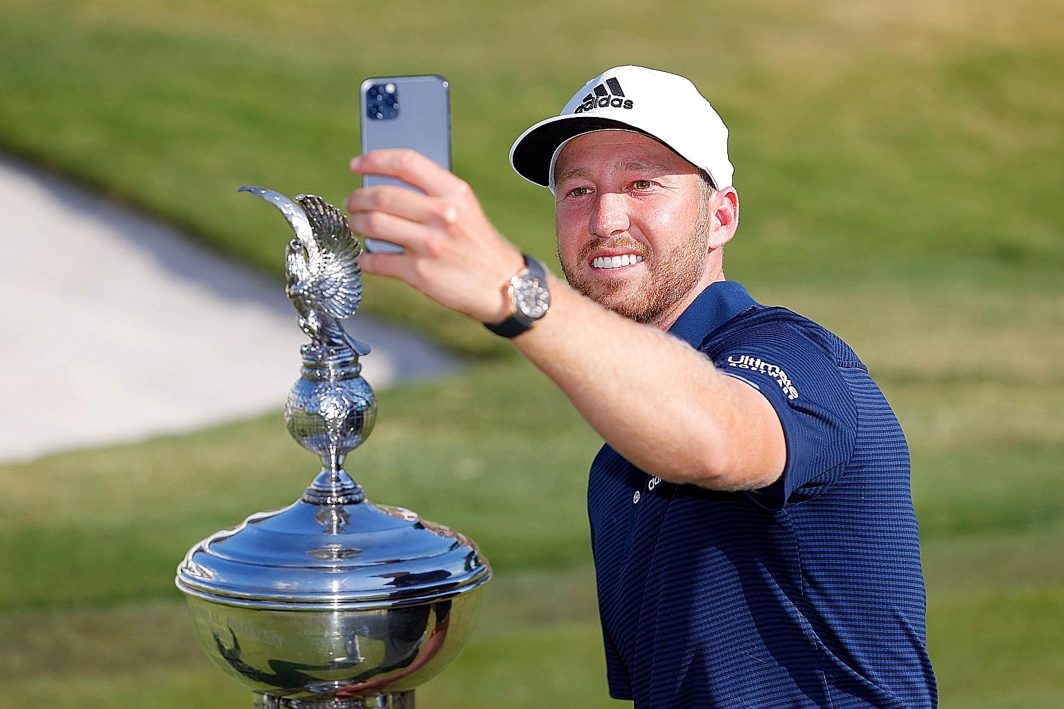 American Daniel Berger taking a selfie after receiving the humongous Leonard Trophy for winning the Charles Schwab Challenge. PHOTO: AGENCE FRANCE-PRESSE