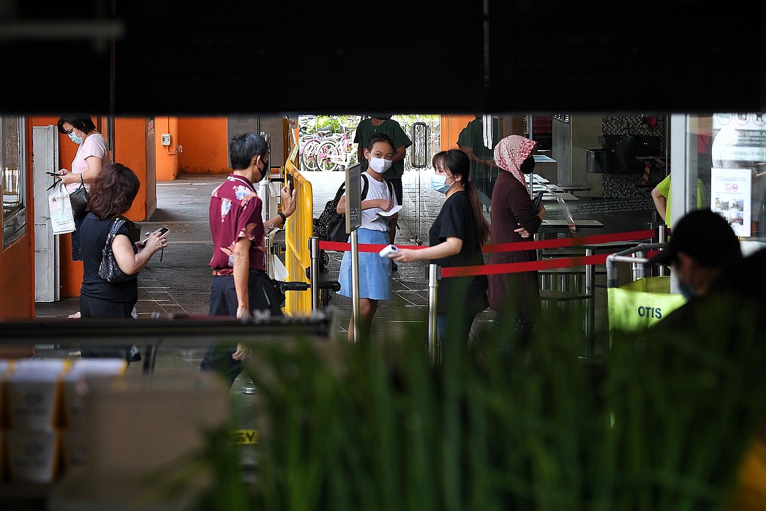People waiting to enter Hougang Mall last week. As more businesses reopen from Friday, steps must be taken to ensure the queues outside malls are properly managed. Failure to do so may result in the mall being asked to close, said National Developmen
