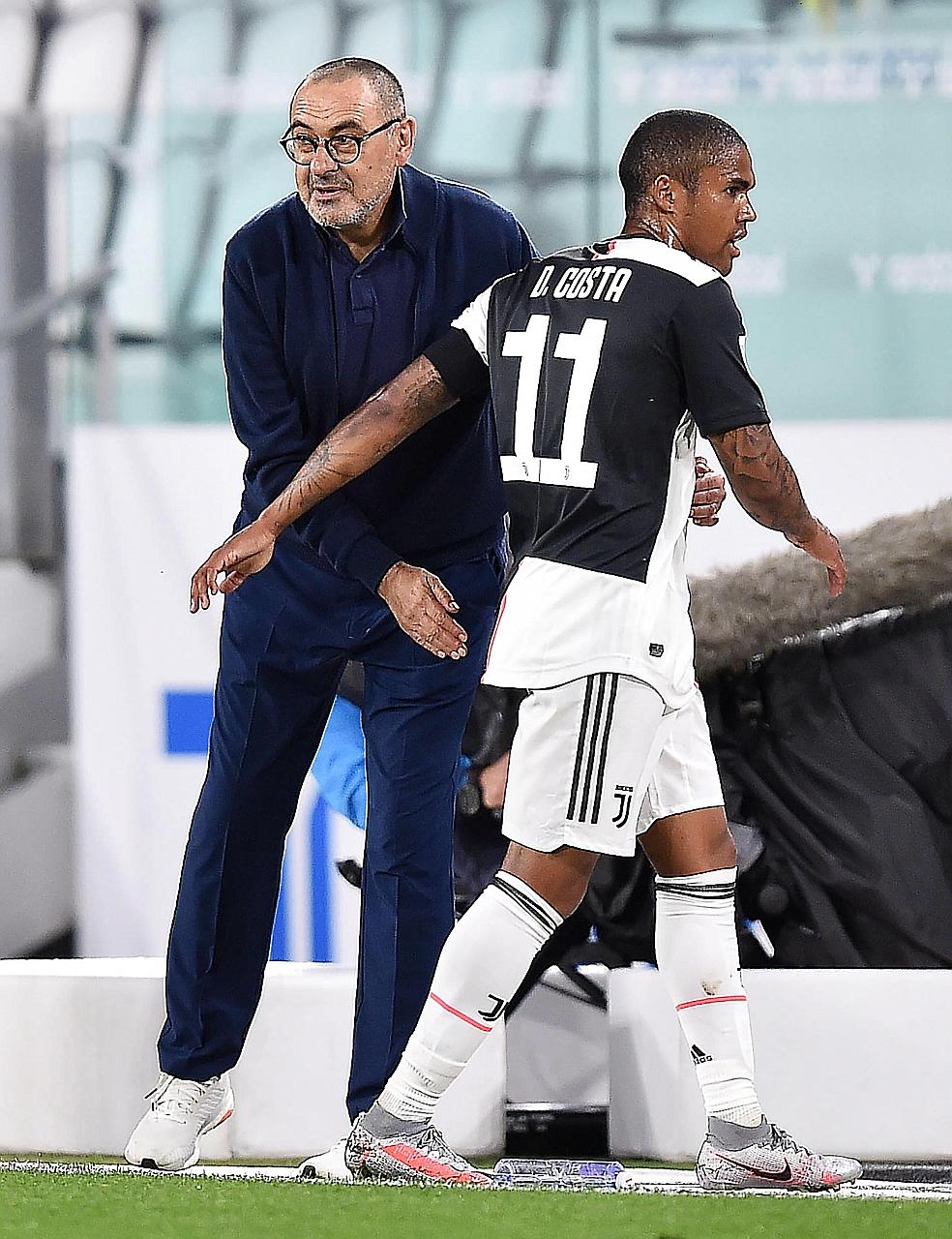 Juventus coach Maurizio Sarri with Douglas Costa after taking him off in the second leg of the Italian Cup semi-final against AC Milan last Friday.