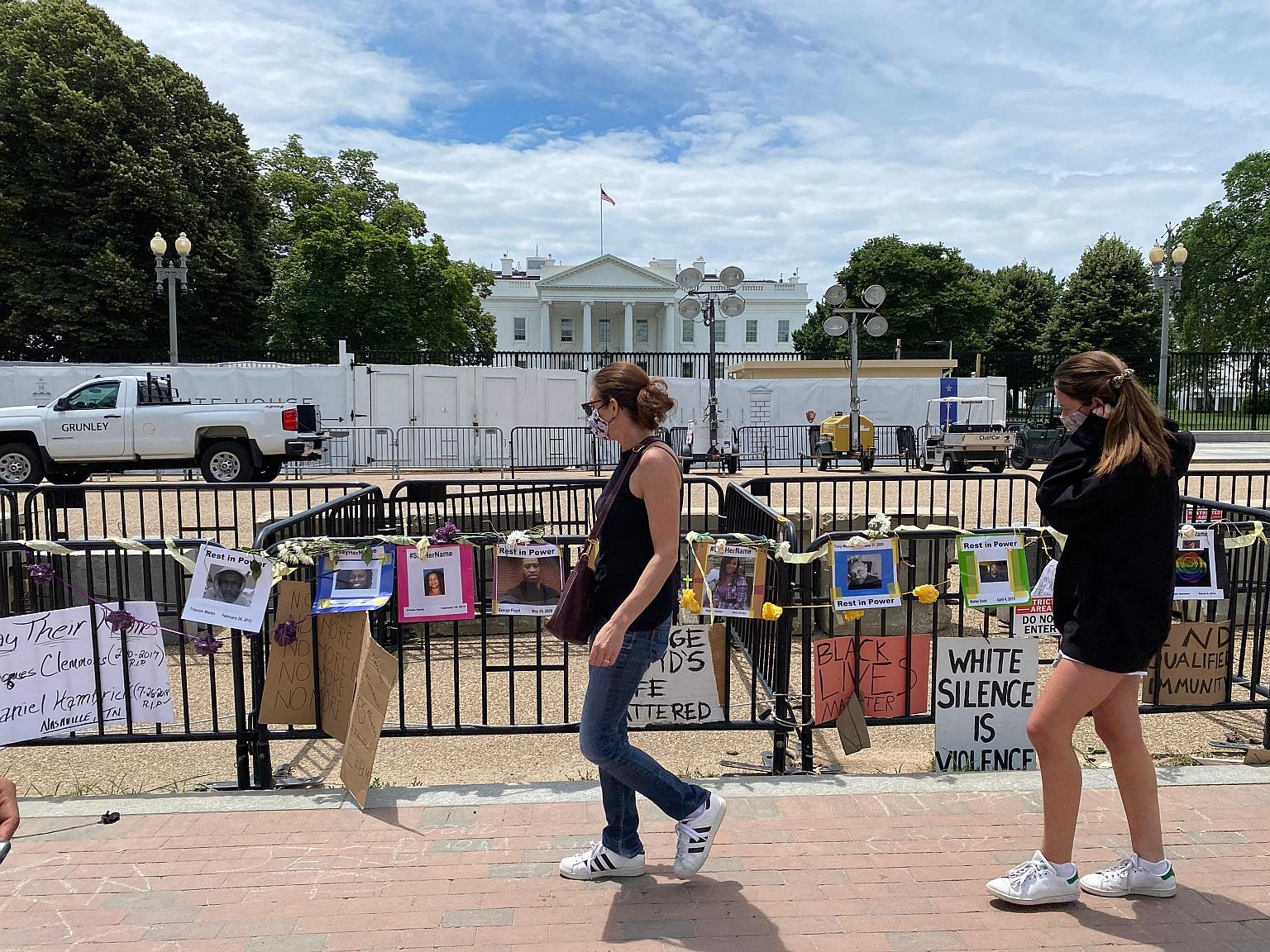 Photo posters and signs, put up by demonstrators protesting against police brutality, hanging from barricades across from the White House in Washington on Monday. American lawmakers are working on legislative responses to the calls for police reform.