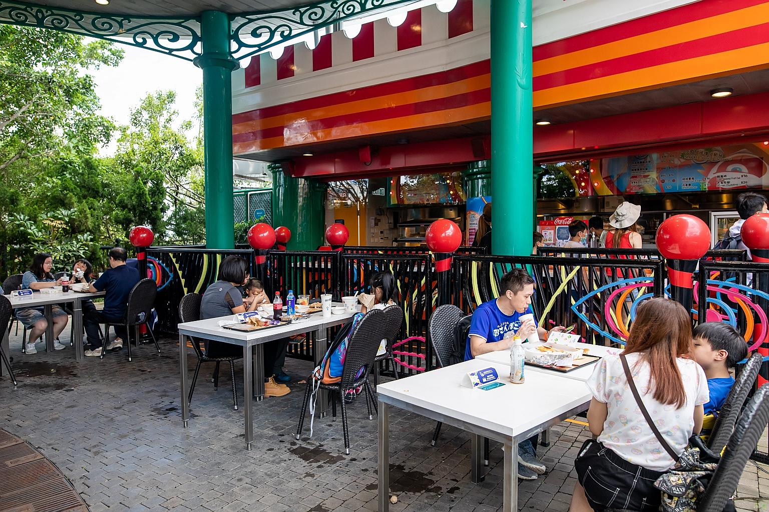 Visitors having their meals at a restaurant in Hong Kong's Ocean Park last Saturday. The theme park reopened that day after being temporarily closed for more than four months due to the Covid-19 pandemic. PHOTO: BLOOMBERG