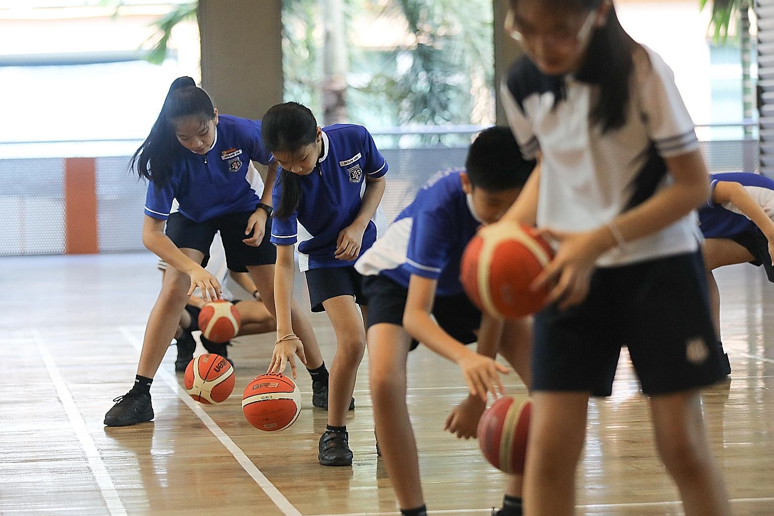 A physical education lesson at Jing Shan Primary School in which pupils have to observe social distancing. For PE lessons, schools will allow group activities and games that involve minimal physical contact or have a small number of players on each s