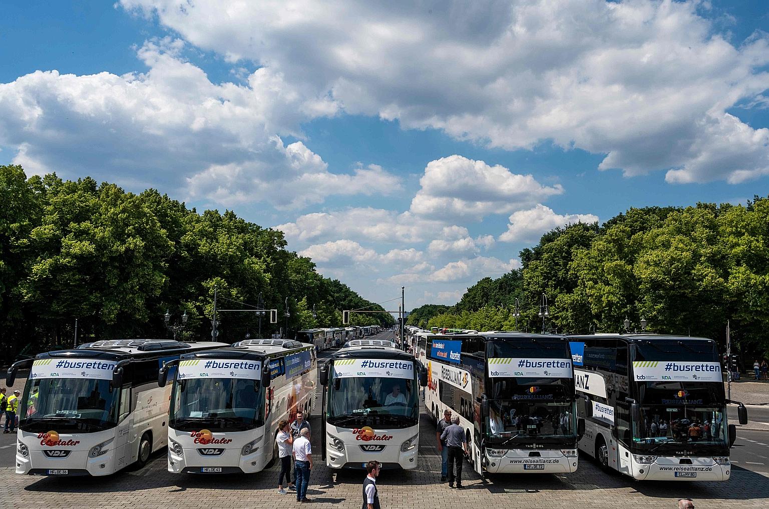 Buses parked in front of the Brandenburg Gate yesterday, during a protest by operators of travel coach companies in Berlin, Germany. They rallied along the 17 Juni Boulevard, asking for more financial help amid the coronavirus pandemic that has cripp