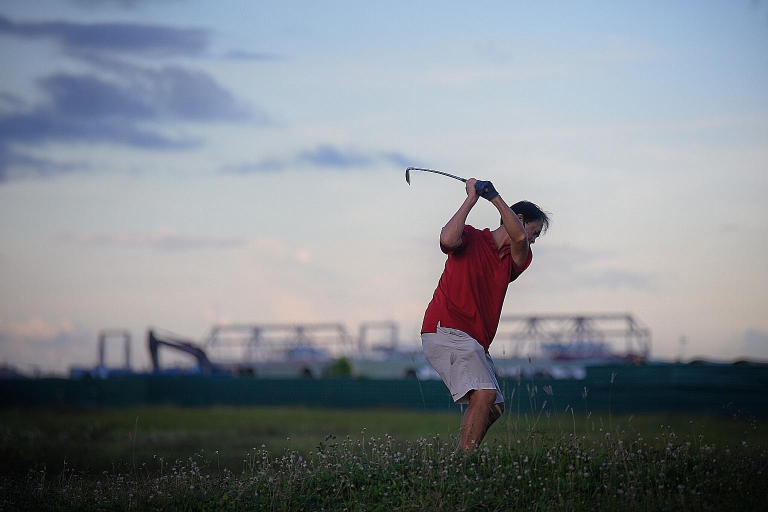 A man practising his golf swing at Gardens By The Bay East during the circuit breaker period. All golf clubs were closed since April 7 in line with the measures to curb the coronavirus pandemic. Below: Buggies at the Orchid Country Club have clear pl
