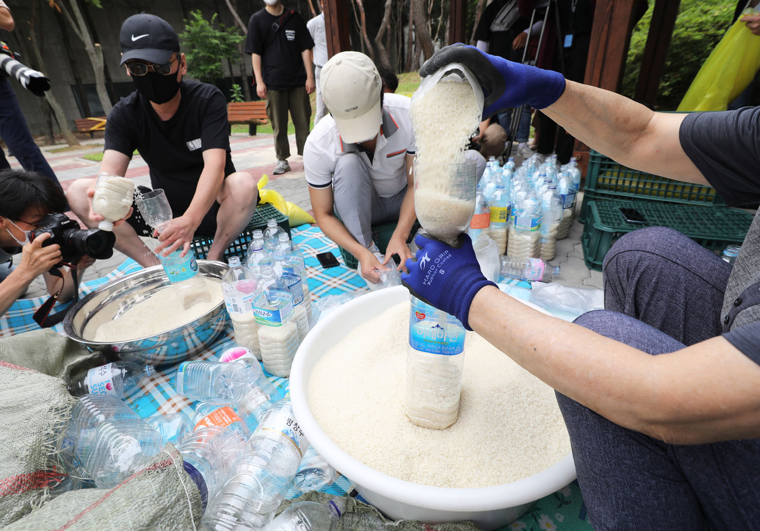 Defector activists putting rice into plastic bottles at a park in Seoul yesterday. They plan to let the bottles float to North Korea via waters off the western island of Ganghwa bordering the North, despite the South Korean government's crackdown on 