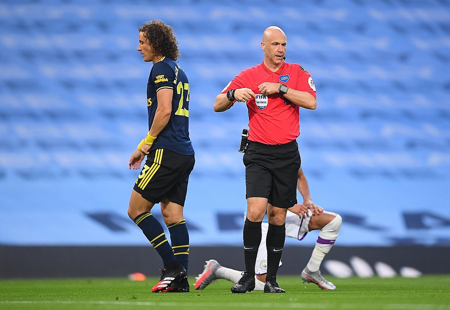Arsenal's David Luiz walking to the dressing room, after being sent off by referee Anthony Taylor in their EPL match against Manchester City at the Etihad Stadium on Wednesday. City won 3-0, with Luiz at fault for two of the goals.