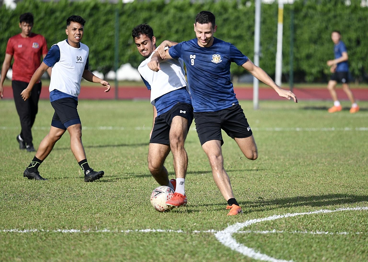 Hougang United striker Stipe Plazibat (right) training ahead of February's Community Shield. Hougang have played just three SPL games since that curtain-raiser owing to the pandemic. But footballers can resume training today. Among the strict rules,