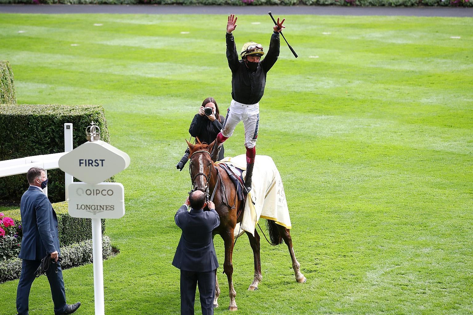 Jockey Frankie Dettori celebrates with his famous flying dismount after winning the Ascot Gold Cup on Stradivarius on Thursday.