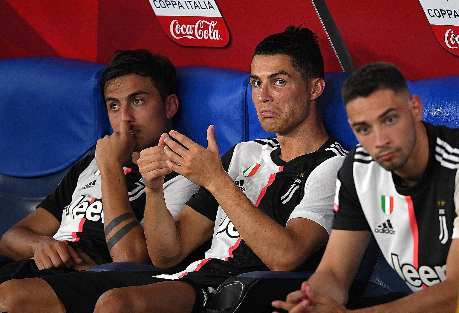 Paulo Dybala (left) and Cristiano Ronaldo feeling dejected after Juventus' shoot-out loss to Napoli in the Italian Cup final on Wednesday. Dybala missed a penalty while Ronaldo was not involved much.