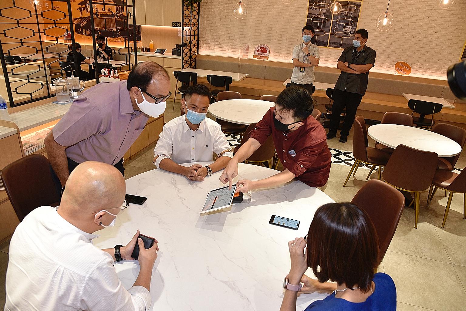 From top right, anti-clockwise: Mr Alan Goh (in brown shirt), Oddle sales and business development director; White Restaurant managing director Victor Tay; Communications and Information Minister S. Iswaran; White Restaurant general manager Sam Lim; and I