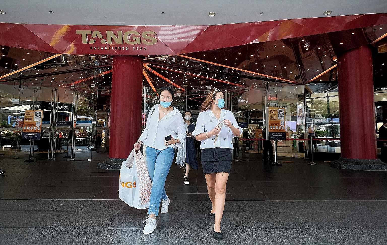 The city came alive again yesterday, the first day of phase two of Singapore's reopening. (From top) People thronging the streets of Orchard Road, albeit wearing face masks; shoppers leaving Tangs department store with their purchases; and customers 