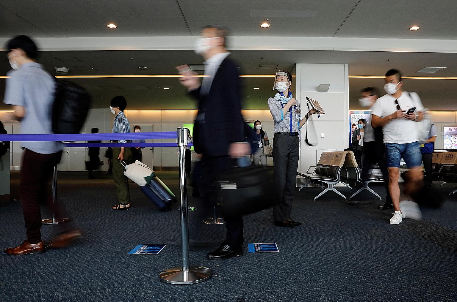 Tokyo's Haneda Airport pictured early this month. Prime Minister Shinzo Abe announced plans to open Japan's borders to business tourists, initially accepting up to 250 daily from countries with low infection rates. PHOTO: REUTERS