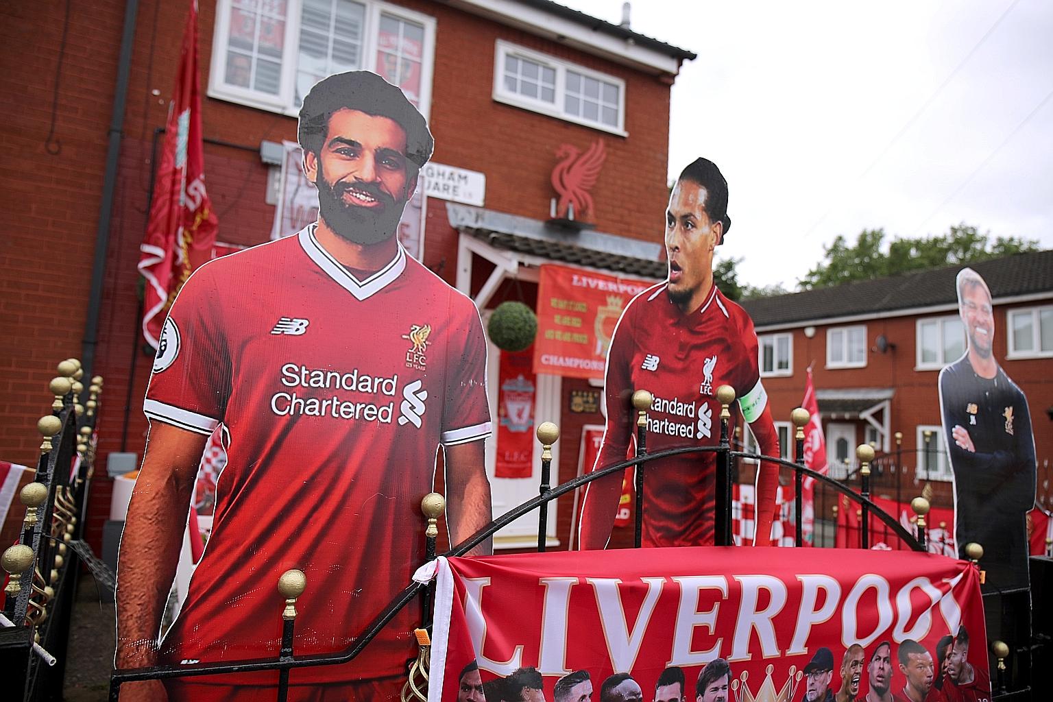 Cut-outs of (from left) Liverpool's Mohamed Salah, Virgil van Dijk and manager Jurgen Klopp are seen outside the house of a Reds fan. PHOTO: REUTERS