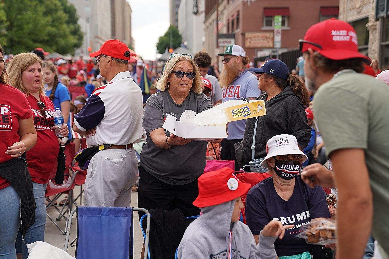 A crowd gathering near the BOK Centre in Tulsa, Oklahoma, yesterday, where President Donald Trump was scheduled to hold his first election campaign rally since March 2. Mr Trump has planned a string of rallies in various states, sparking fears that t