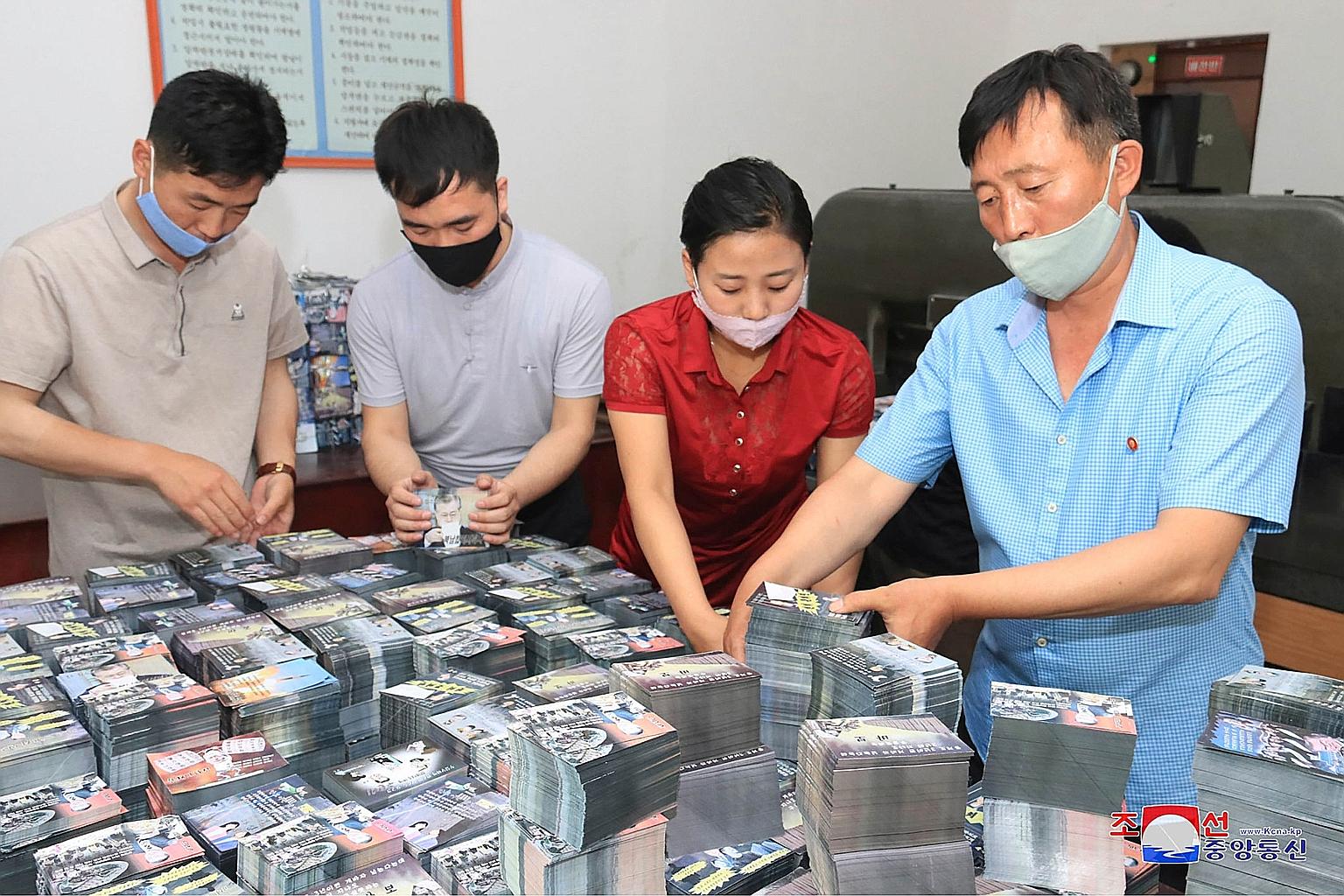 People preparing anti-South leaflets at an undisclosed location in North Korea. State news agency KCNA said enraged North Korean people across the country "are actively pushing forward with the preparations for launching a large-scale distribution of