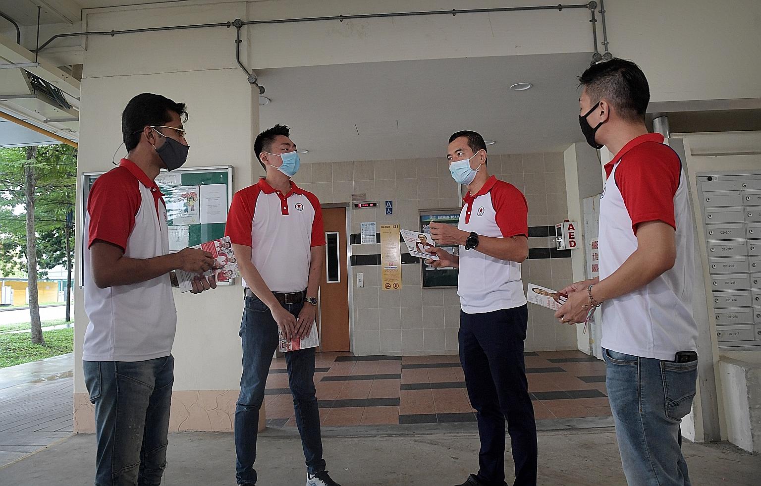 From left: Singapore People's Party candidates Osman Sulaiman, Melvyn Chiu, Steve Chia and Williiamson Lee preparing to hand out fliers and meet residents at Block 131, Bishan Street 12, yesterday.